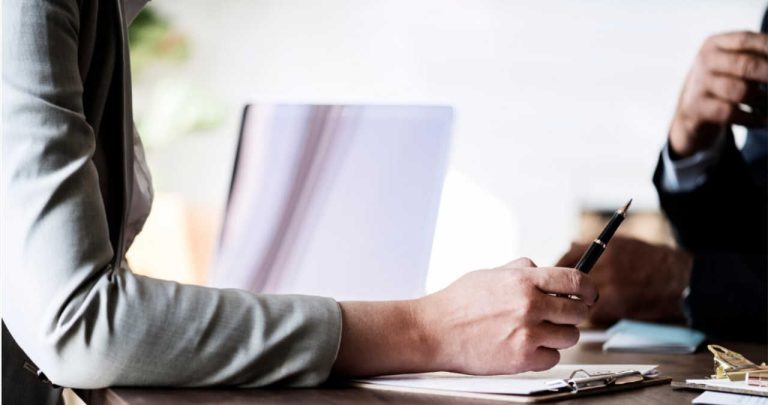 Un judecător analizând un dosar de litigiu de muncă privind o decizie de concediere abuzivă pe biroul său din Tribunal